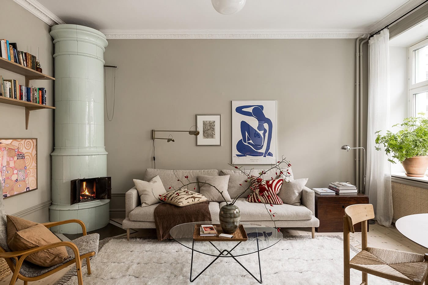 A mint green fireplace and a bedroom wallpaper mural in a historic home