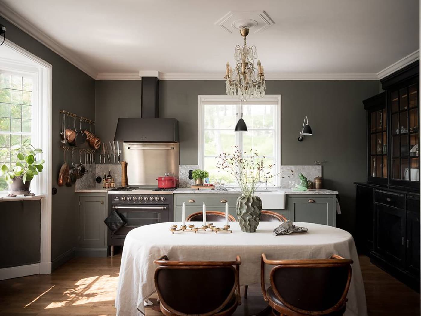 A majestic house with a deep green kitchen and historic details