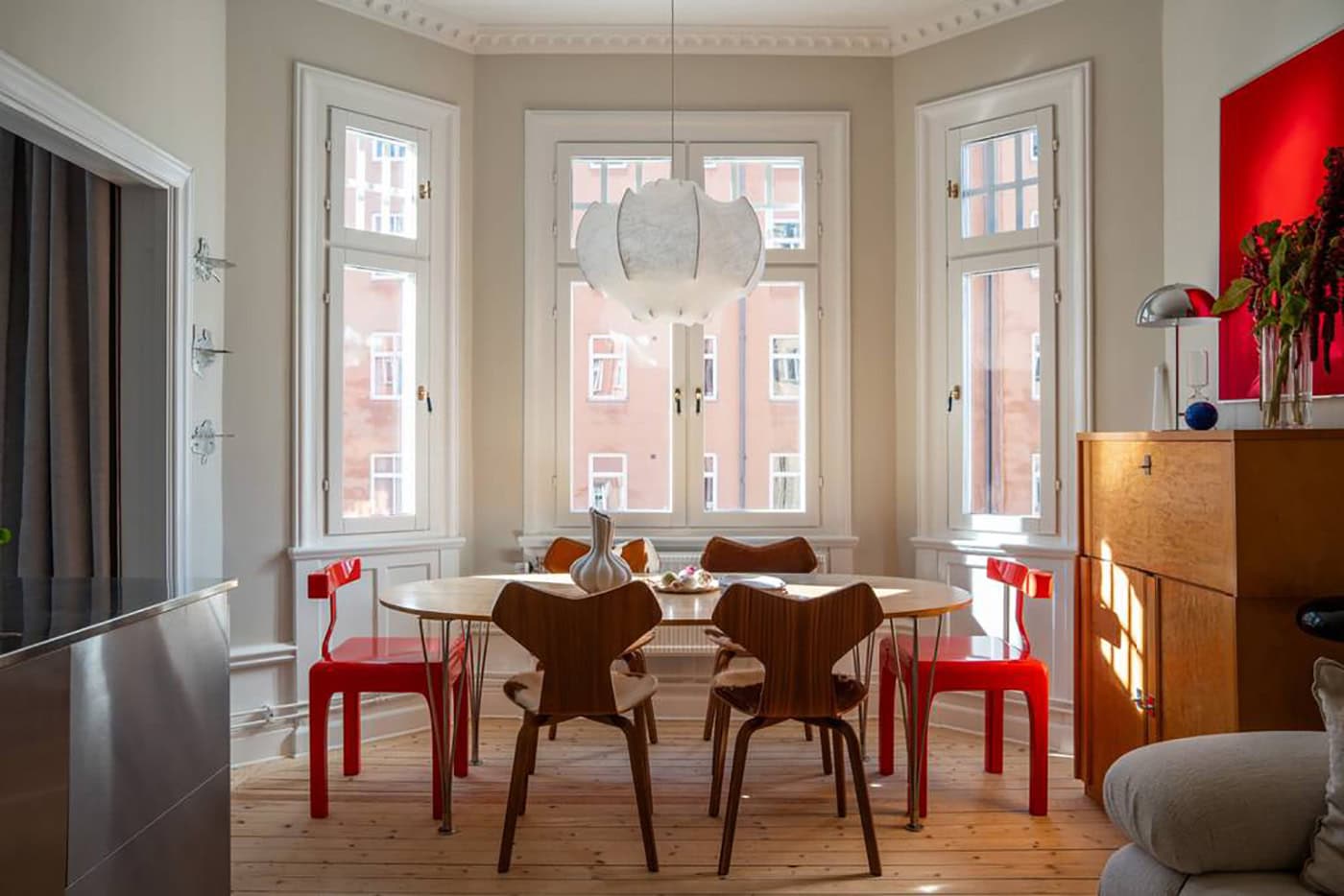 A stainless steel kitchen in a historic home decorated with red accents