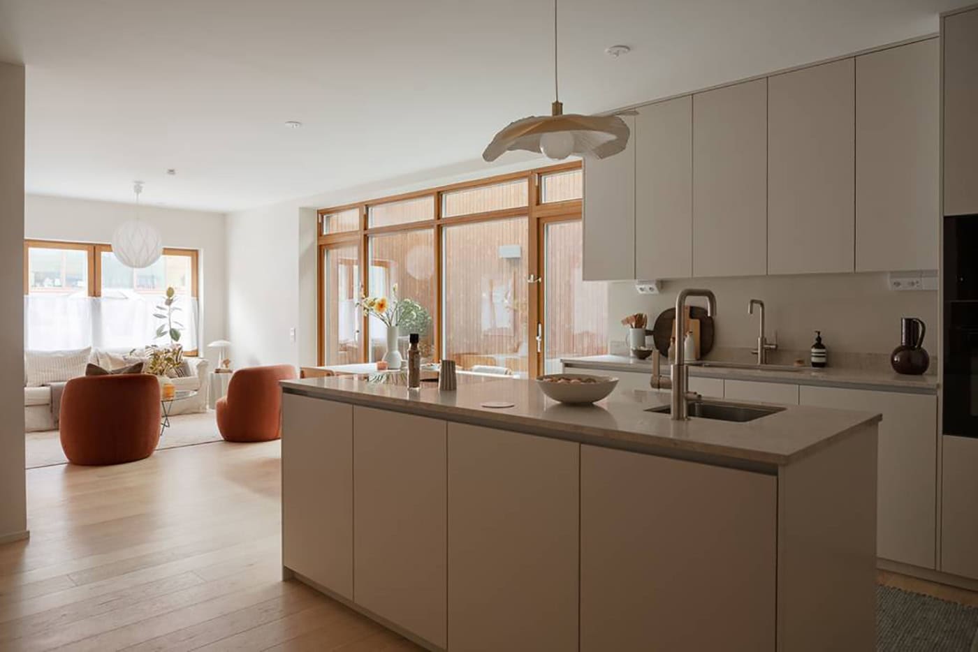 A modern open-plan apartment with a wood panneled patio